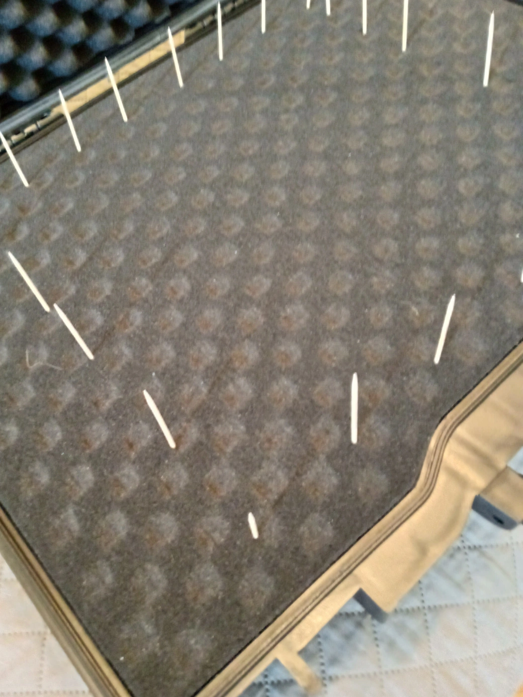 Close-up of toothpick marking technique for outlining Maschine MK3 shape in foam